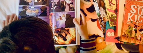 Child looking at comic books